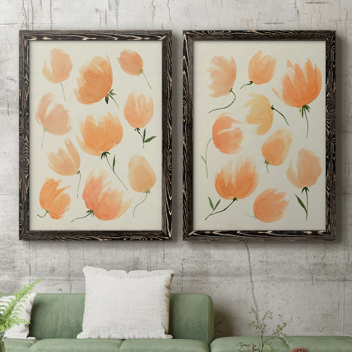 Set of two black barnwood framed canvas prints depicting a coordinated art pair of loose peach-orange tulip-like blossoms rendered as airy watercolor floral paintings above a sofa in a modern living room.