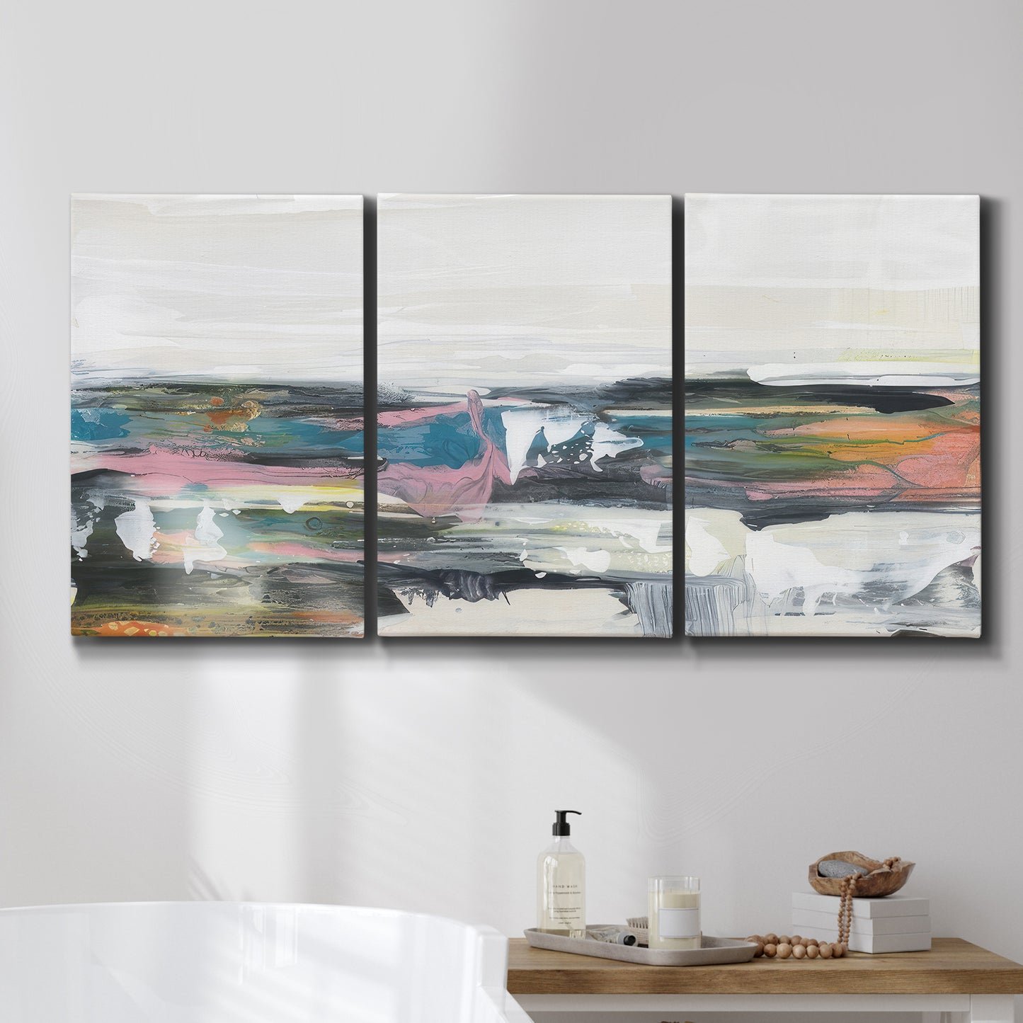 Three-panel canvas wall art featuring cheerful abstract coastal seascape, displayed in a bathroom above a bathtub.