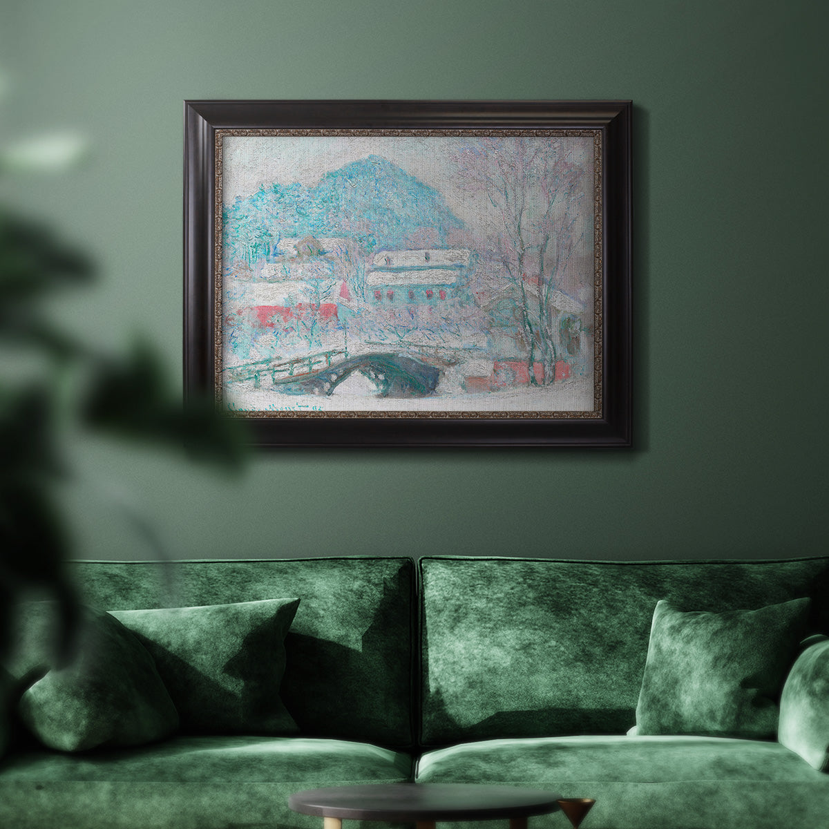 Impressionist coastal village landscape in Norway by Claude Monet in an ornate black frame with gilded inner detail displayed in a dark-toned interior setting.