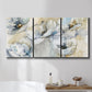 Three-panel canvas wall art featuring delicate watercolor floral blooms, displayed in a bathroom above a bathtub.