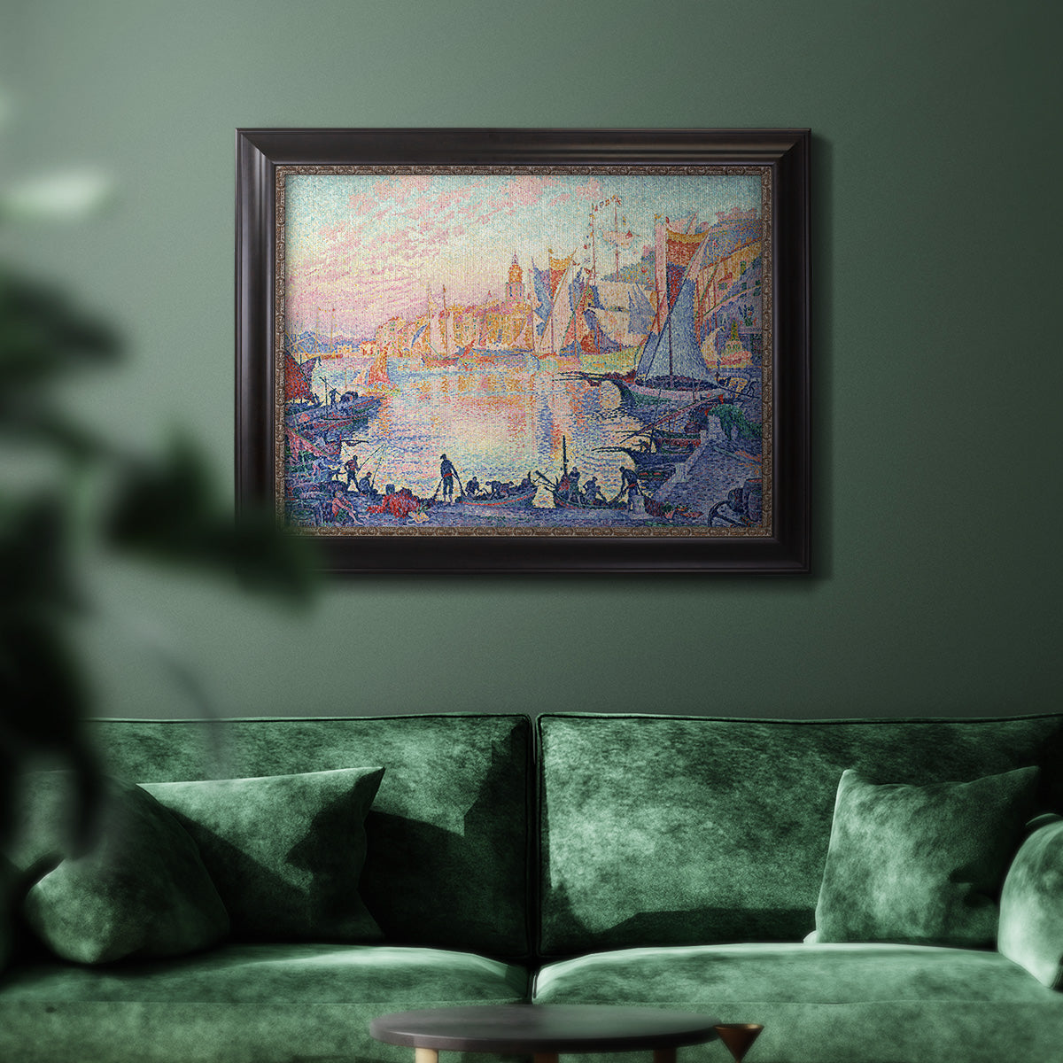 Impressionist Mediterranean harbor painting by Paul Signac in an ornate black frame with gilded inner detail displayed in a dark-toned interior setting.