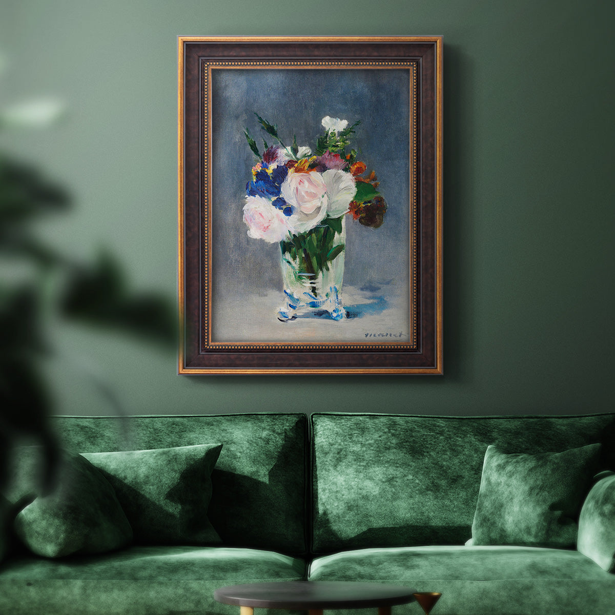Impressionist floral still life painting by Claude Monet in an ornate bronzed mahogany wood frame displayed in a dark-toned interior setting.