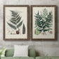 Set of two walnut barnwood framed canvas prints depicting a coordinated art pair of vintage fern specimens with botanical details rendered as natural-history fern plates above a sofa in a modern living room.