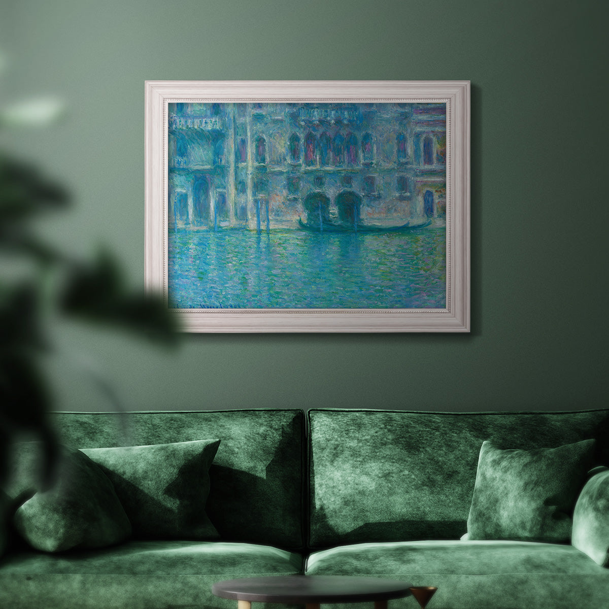Impressionist Venetian palace waterfront scene by Claude Monet in an ornate weathered white frame displayed in a dark-toned interior setting.