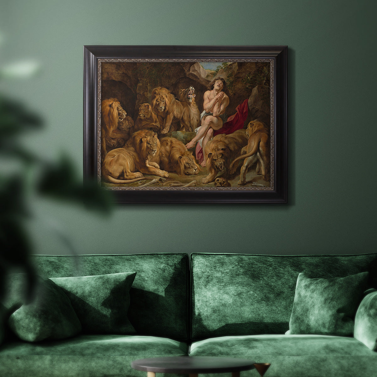Dramatic biblical painting of Daniel with lions by Peter Paul Rubens in an ornate black frame with gilded inner detail displayed in a dark-toned interior setting.
