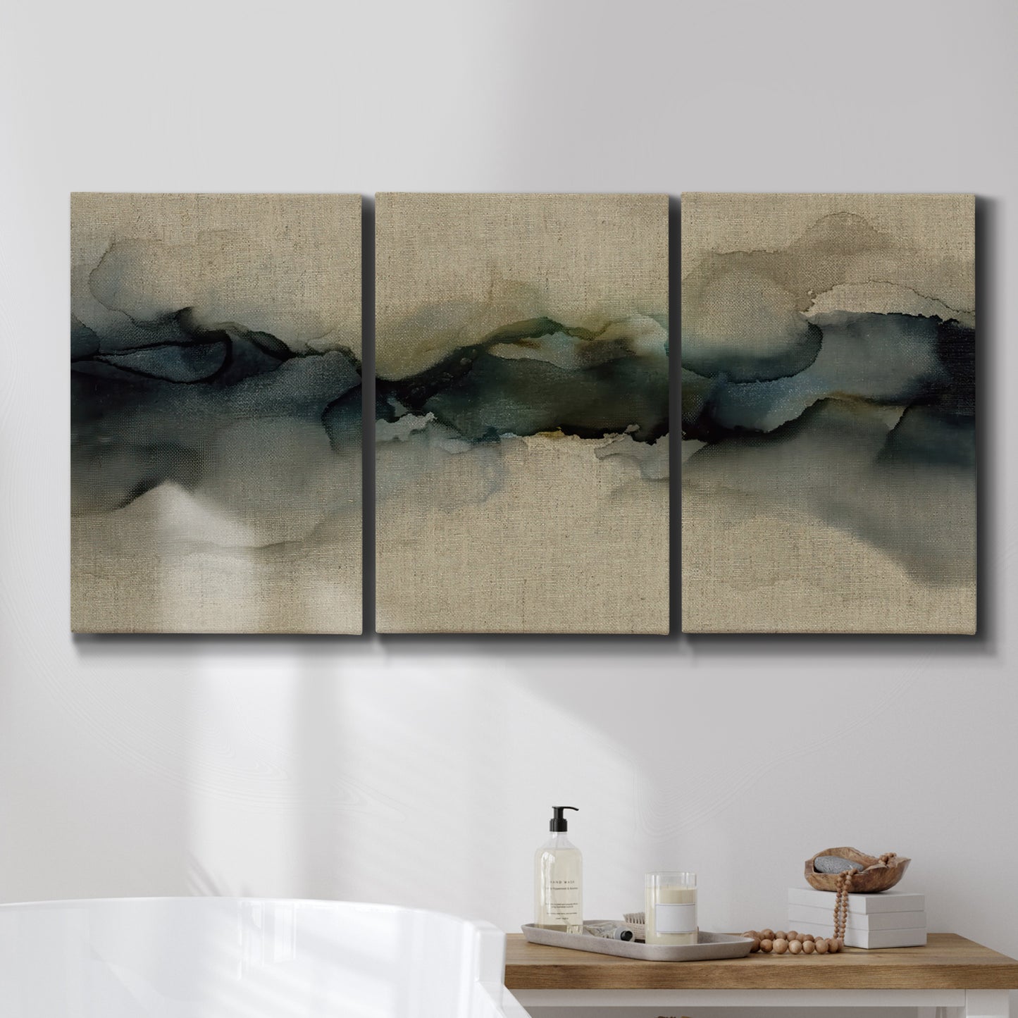 Three-panel canvas wall art featuring calm abstract water surface stillness, displayed in a bathroom above a bathtub.