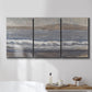 Three-panel canvas wall art featuring shoreline between land and sea, displayed in a bathroom above a bathtub.