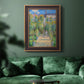 Impressionist garden landscape painting by Claude Monet in an ornate bronzed mahogany wood frame displayed in a dark-toned interior setting.