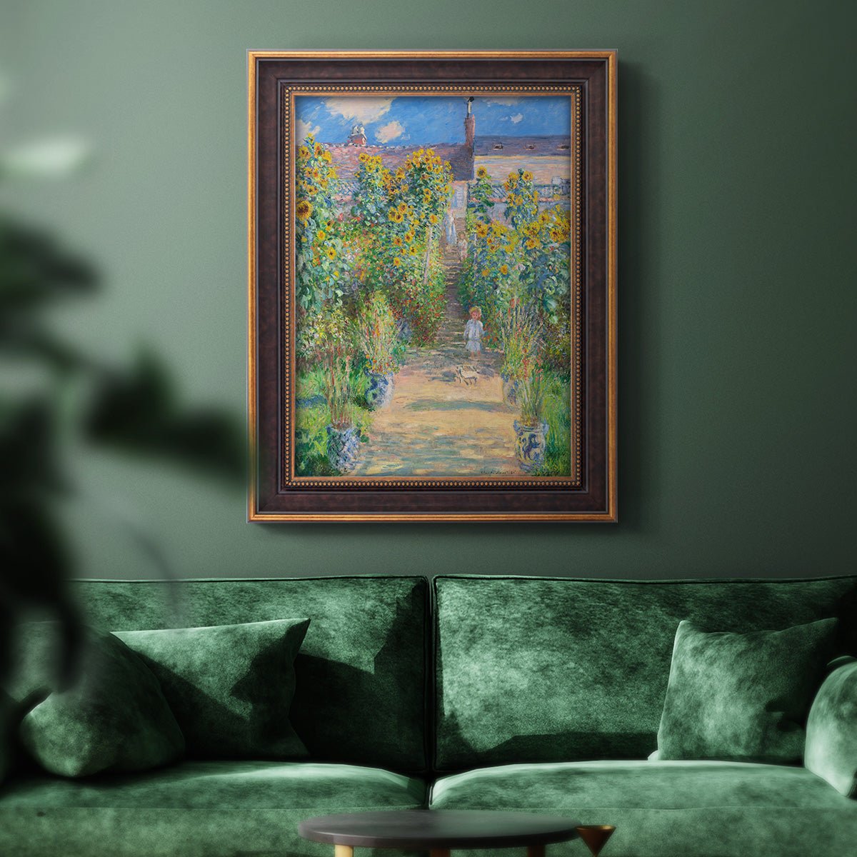Impressionist garden landscape painting by Claude Monet in an ornate bronzed mahogany wood frame displayed in a dark-toned interior setting.