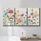 Three-panel canvas wall art featuring delicate wildflower illustration, displayed in a bathroom above a bathtub.