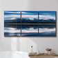 Three-panel canvas wall art featuring calm lake beneath mountains photograph, displayed in a bathroom above a bathtub.
