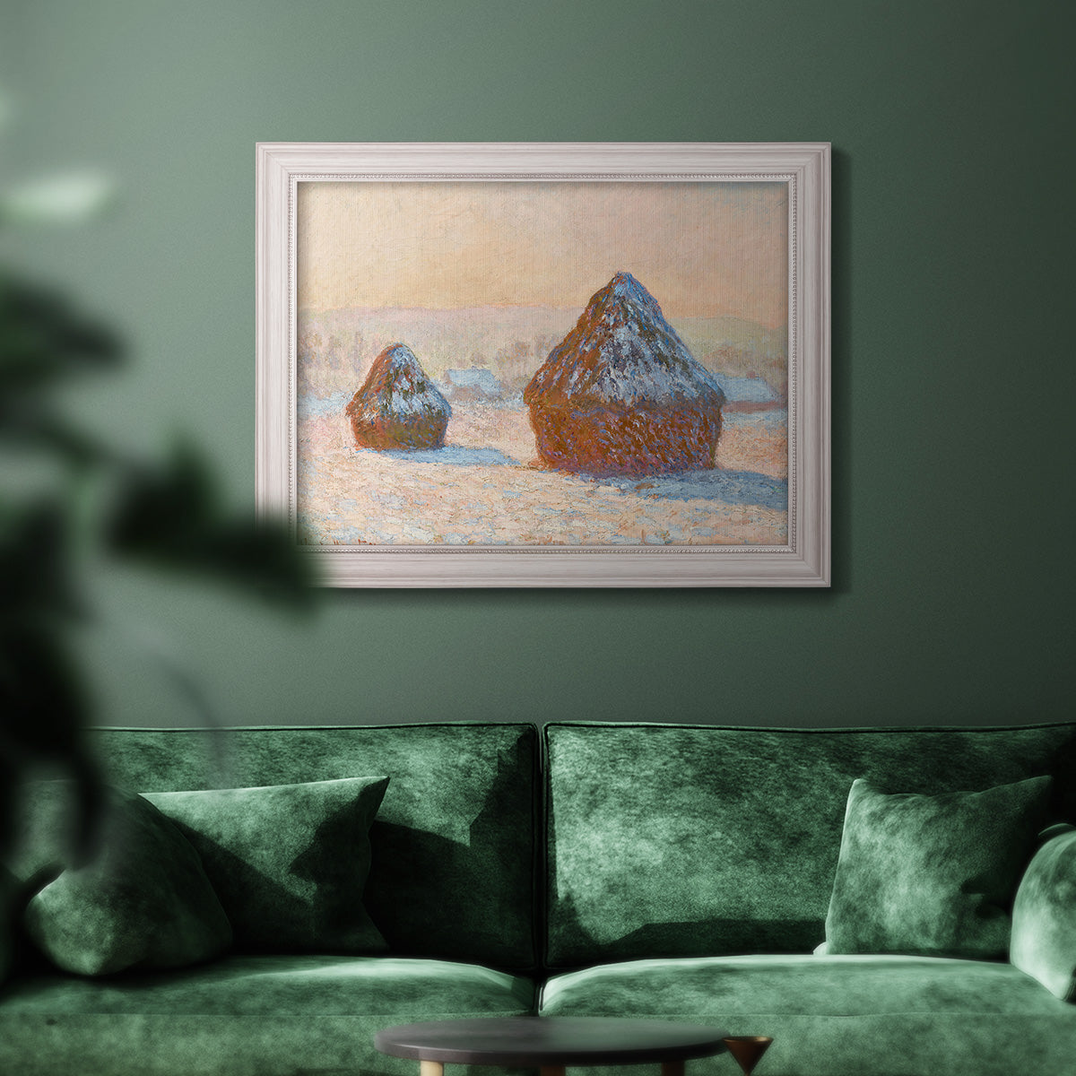 Impressionist winter haystack scene by Claude Monet in an ornate weathered white frame displayed in a dark-toned interior setting.
