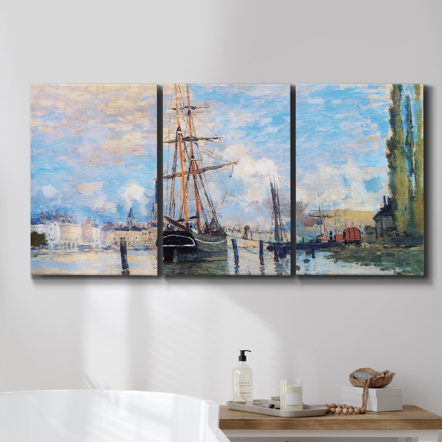 Three-panel canvas wall art featuring busy river port scene, displayed in a bathroom above a bathtub.