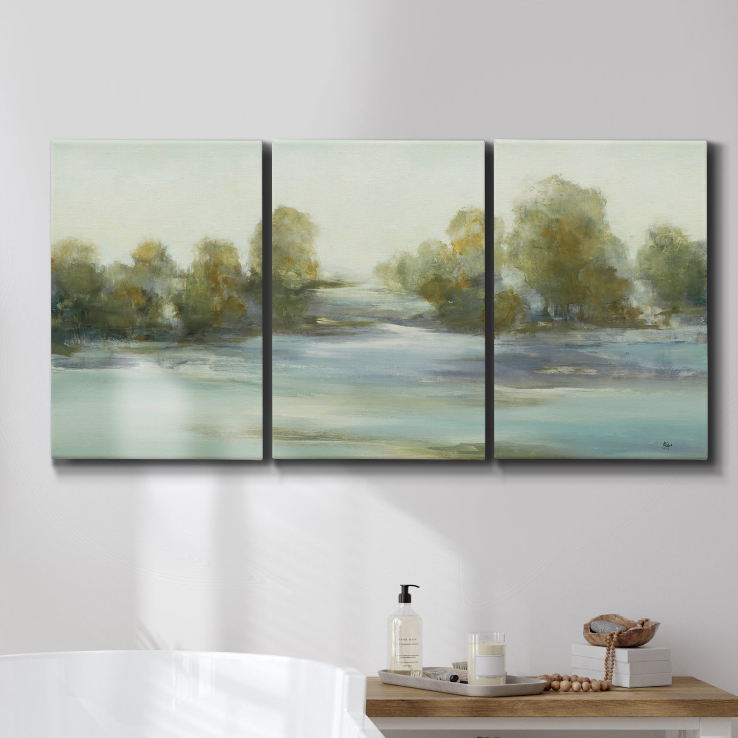 Three-panel canvas wall art featuring calming scenic landscape view, displayed in a bathroom above a bathtub.