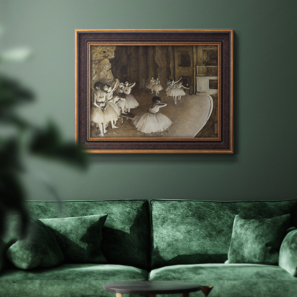 Impressionist ballet rehearsal scene by Edgar Degas in an ornate bronzed mahogany wood frame displayed in a dark-toned interior setting.