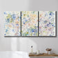 Three-panel canvas wall art featuring flowing abstract watercolor, displayed in a bathroom above a bathtub.