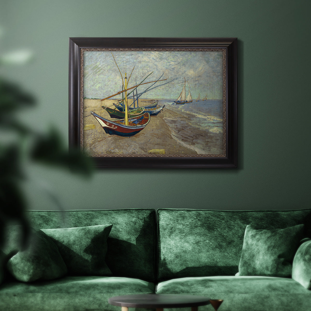 Impressionist coastal fishing boats scene by Vincent van Gogh in an ornate black frame with gilded inner detail displayed in a dark-toned interior setting.