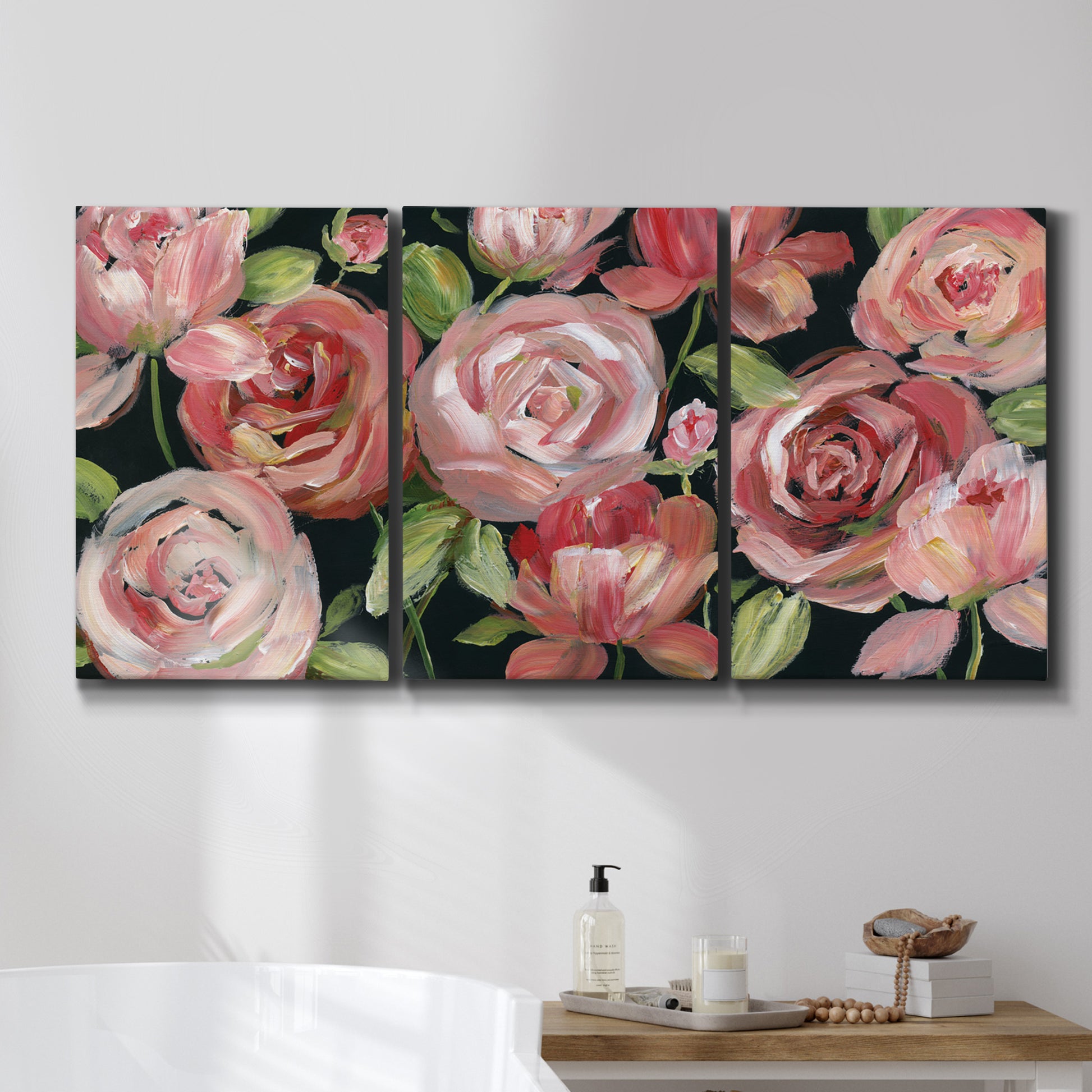 Three-panel canvas wall art featuring bold red floral abstraction, displayed in a bathroom above a bathtub.