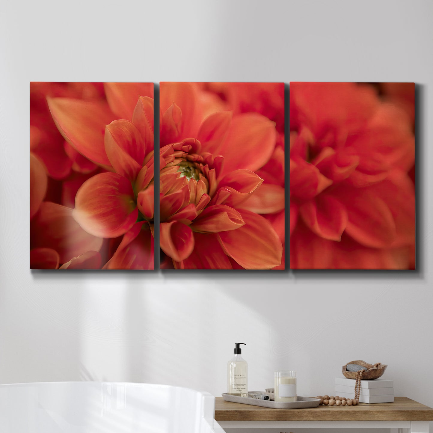Three-panel canvas wall art featuring vivid red floral close up, displayed in a bathroom above a bathtub.