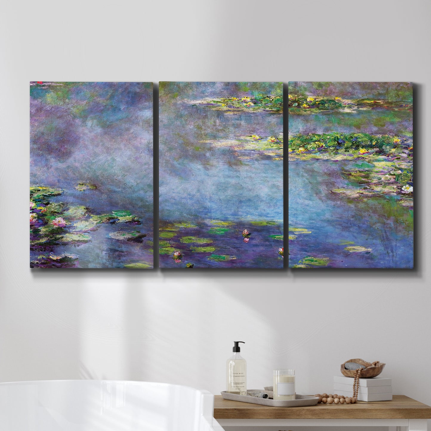 Three-panel canvas wall art featuring water lilies emerging through mist, displayed in a bathroom above a bathtub.