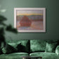 Impressionist haystack sunset scene in winter by Claude Monet in an ornate weathered white frame displayed in a dark-toned interior setting.