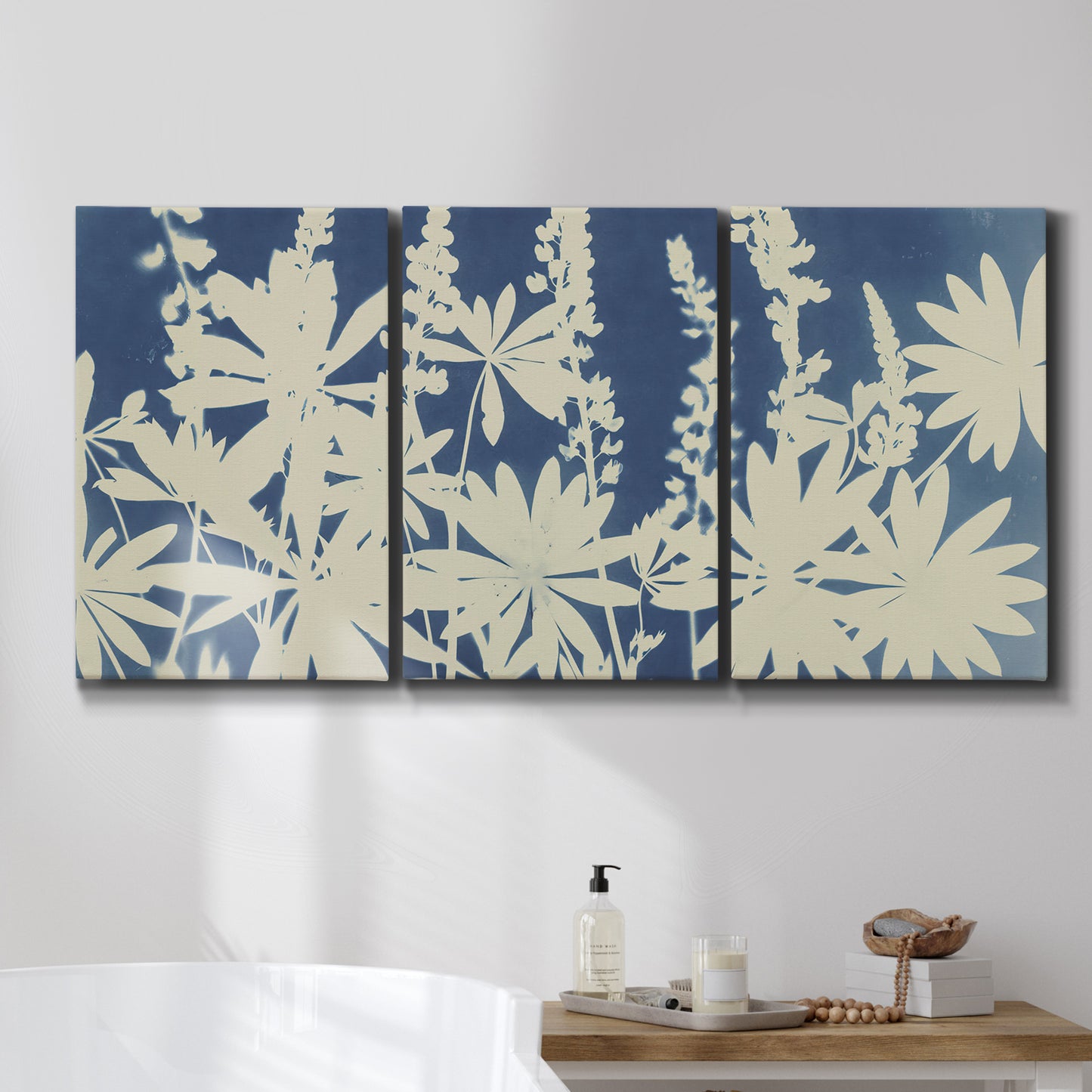Three-panel canvas wall art featuring delicate lupine floral composition, displayed in a bathroom above a bathtub.