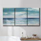 Three-panel canvas wall art featuring calm coastal shoreline, displayed in a bathroom above a bathtub.