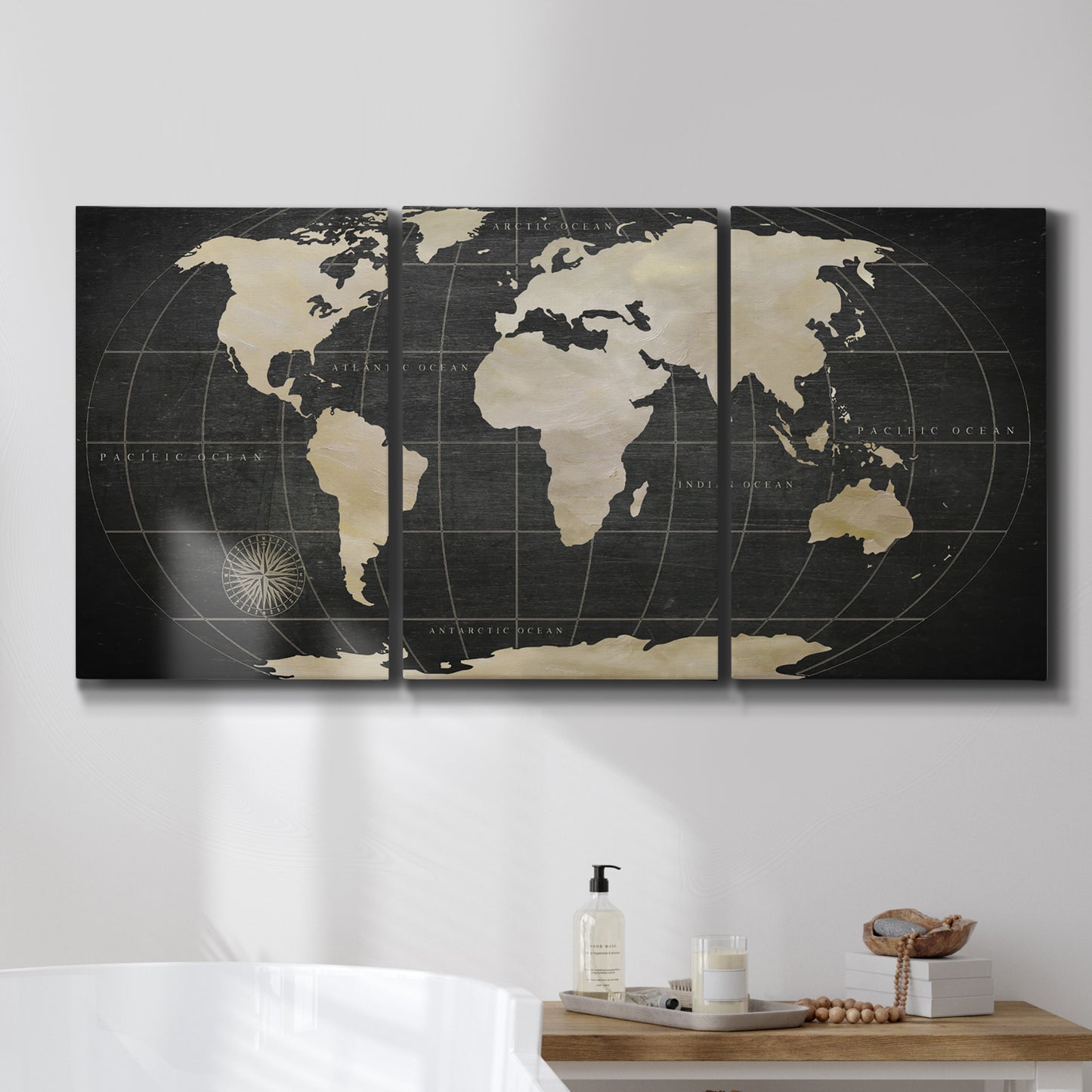 Three-panel canvas wall art featuring antique world map illustration, displayed in a bathroom above a bathtub.