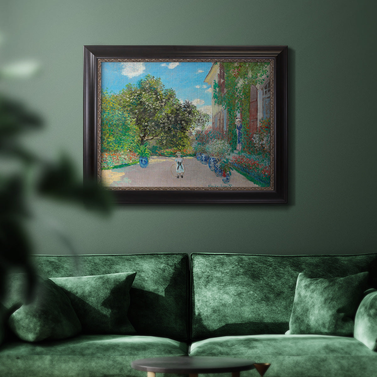 Impressionist residential landscape at Argenteuil by Claude Monet in an ornate black frame with gilded inner detail displayed in a dark-toned interior setting.