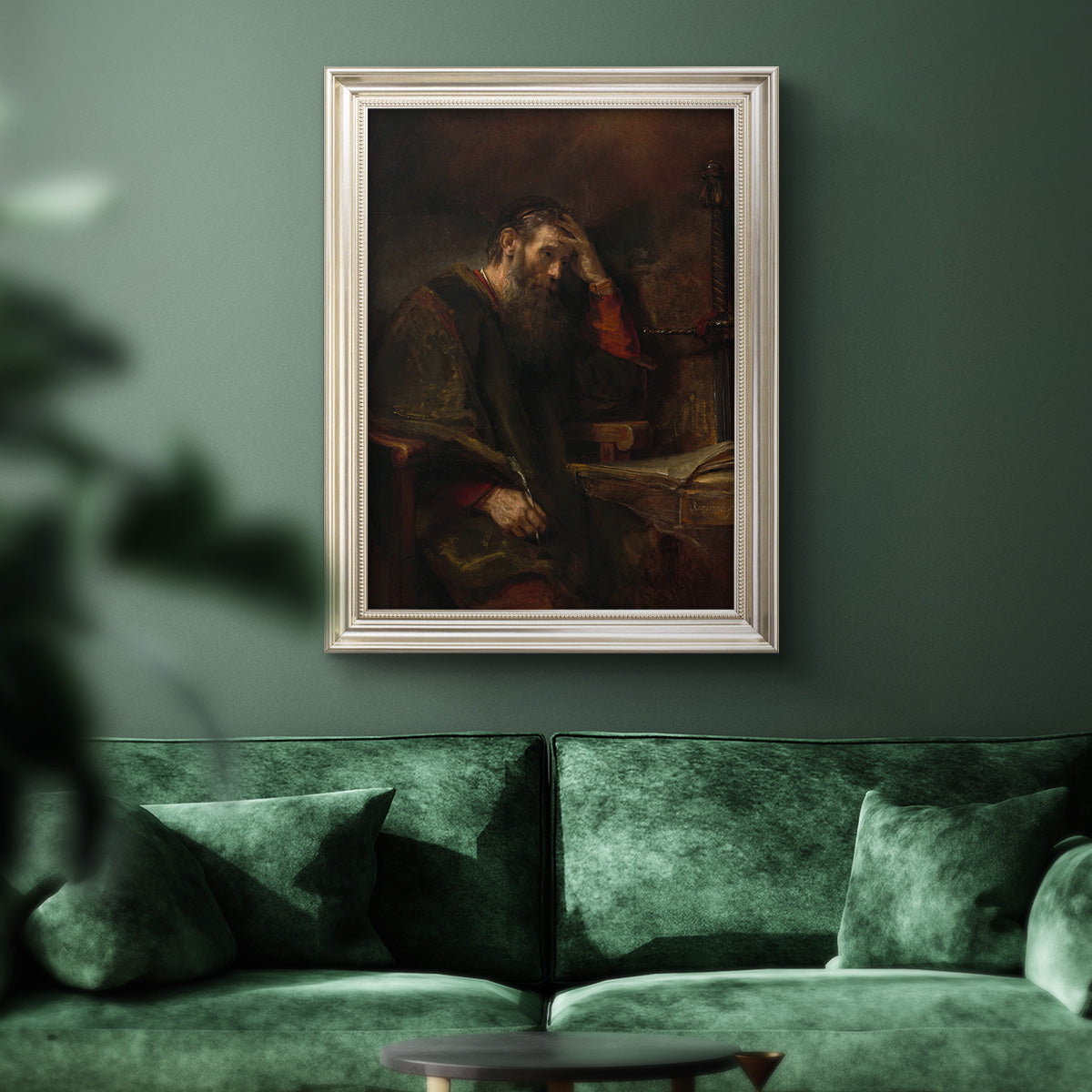 Classical religious portrait of Paul the Apostle by Rembrandt van Rijn in an ornate champagne frame displayed in a dark-toned interior setting.