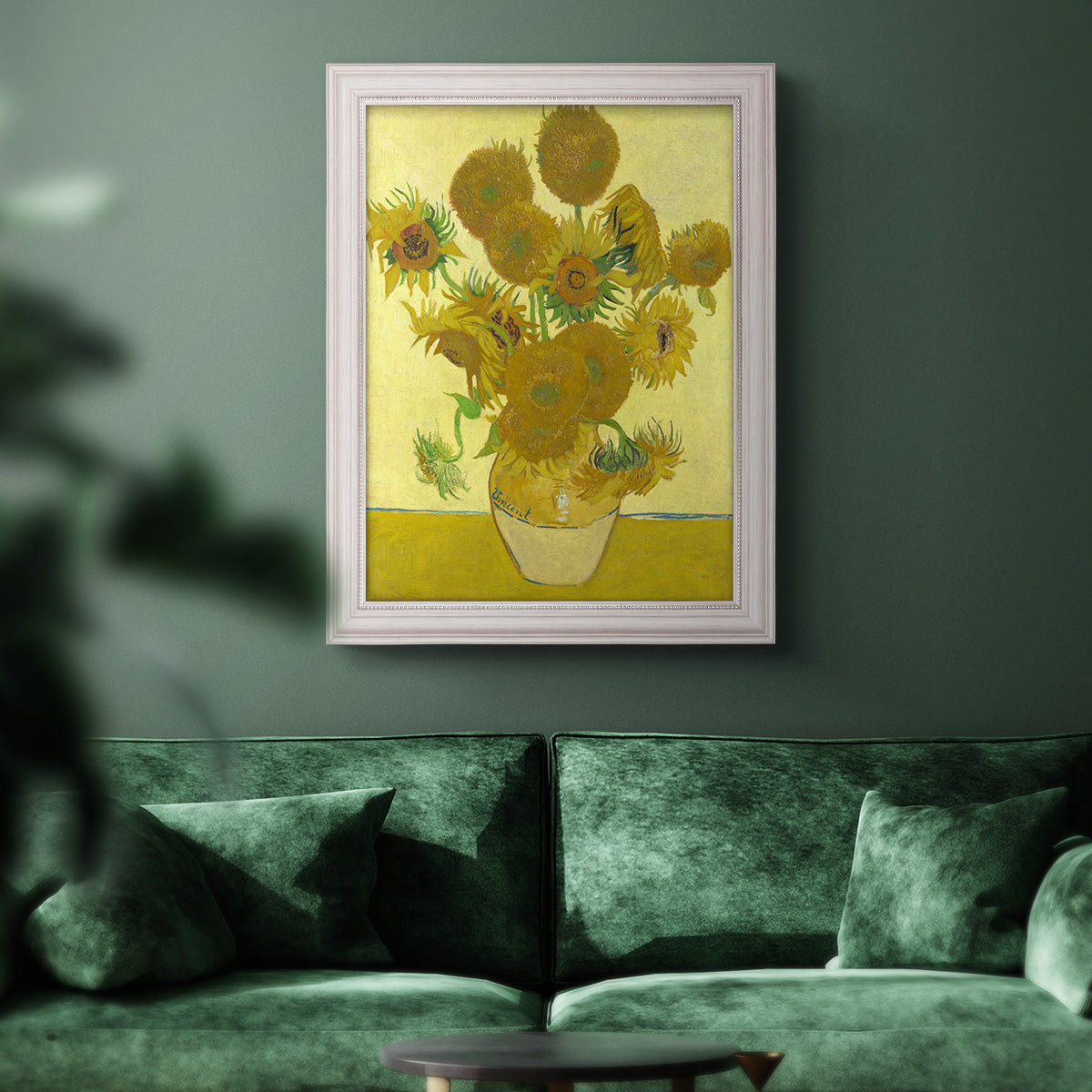Impressionist sunflower still life painting by Vincent van Gogh in an ornate weathered white frame displayed in a dark-toned interior setting.