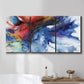 Three-panel canvas wall art featuring vibrant abstract color explosion, displayed in a bathroom above a bathtub.