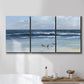 Three-panel canvas wall art featuring loose farmhouse style floral painting, displayed in a bathroom above a bathtub.