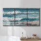 Three-panel canvas wall art featuring crashing ocean waves along shoreline, displayed in a bathroom above a bathtub.