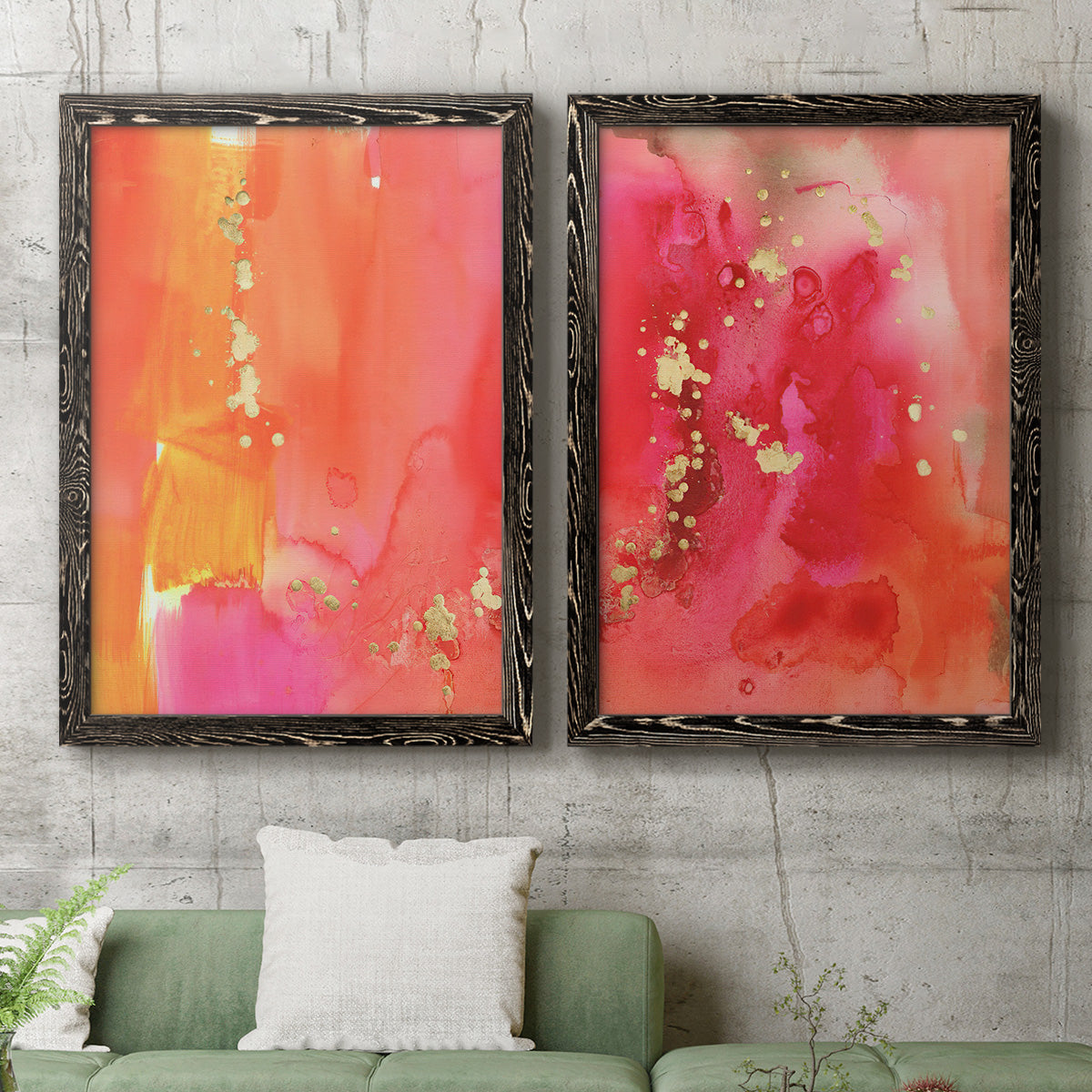 Set of two black barnwood framed canvas prints depicting a coordinated art pair of luminous coral orange and pink color fields with gold flecks rendered as glamorous fluid abstracts above a sofa in a modern living room.