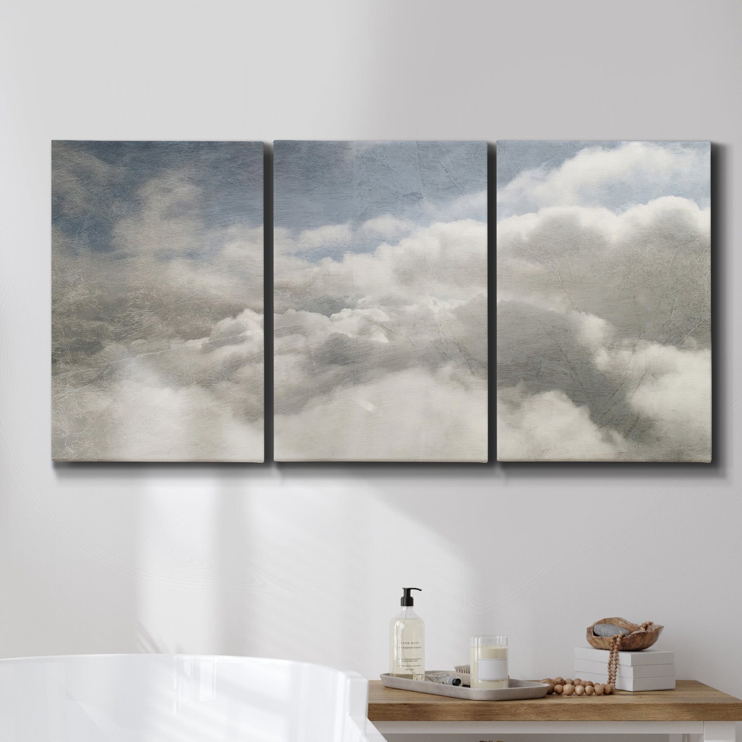Three-panel canvas wall art featuring aerial landscape view photograph, displayed in a bathroom above a bathtub.