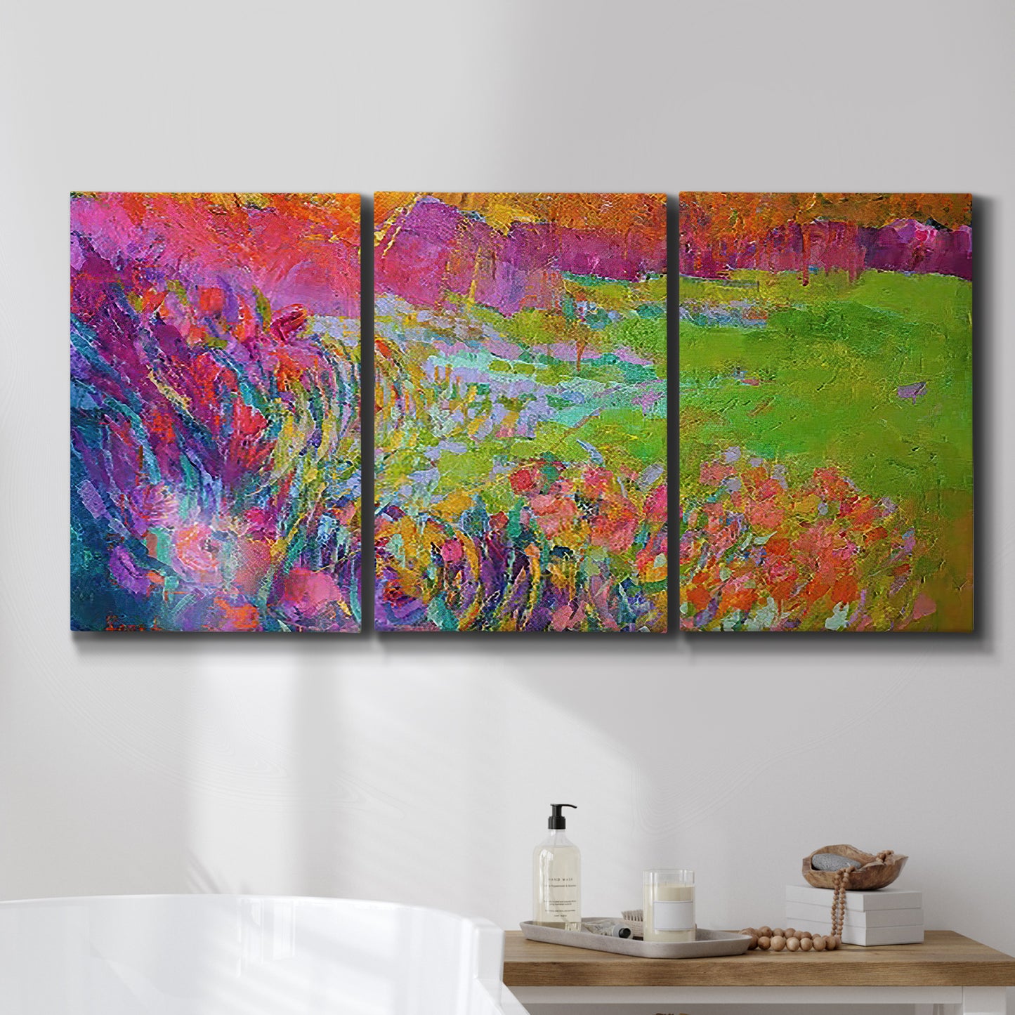 Three-panel canvas wall art featuring abstract meadow inspired color fields, displayed in a bathroom above a bathtub.