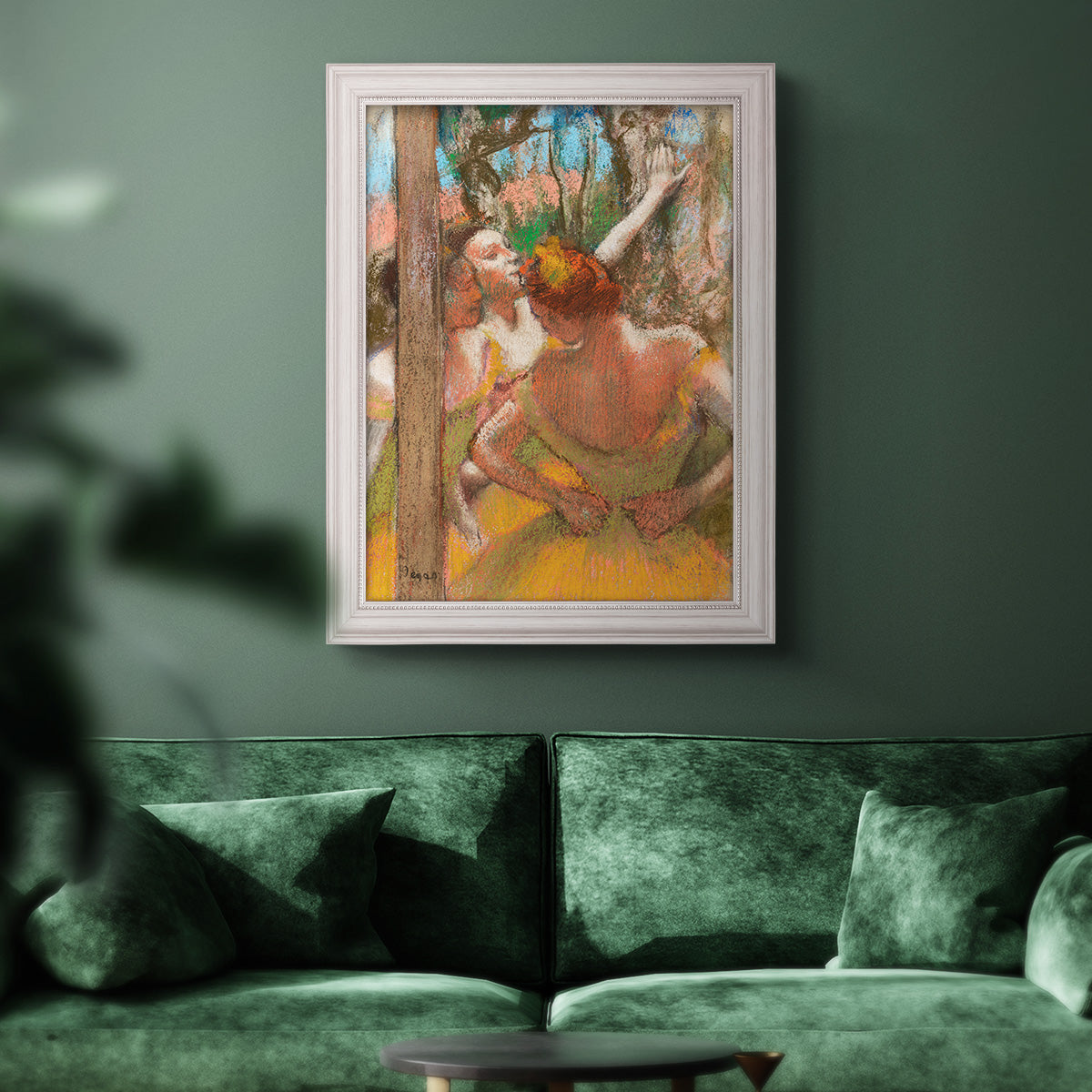 Impressionist ballet dancer composition by Edgar Degas in an ornate weathered white frame displayed in a dark-toned interior setting.