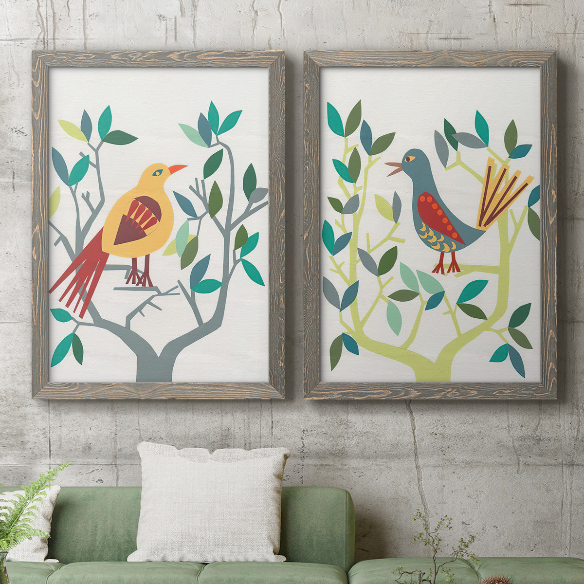 Set of two gray barnwood framed canvas prints depicting a coordinated art pair of stylized colorful birds perched among leafy branches rendered as modern folk-art bird illustrations above a sofa in a modern living room.