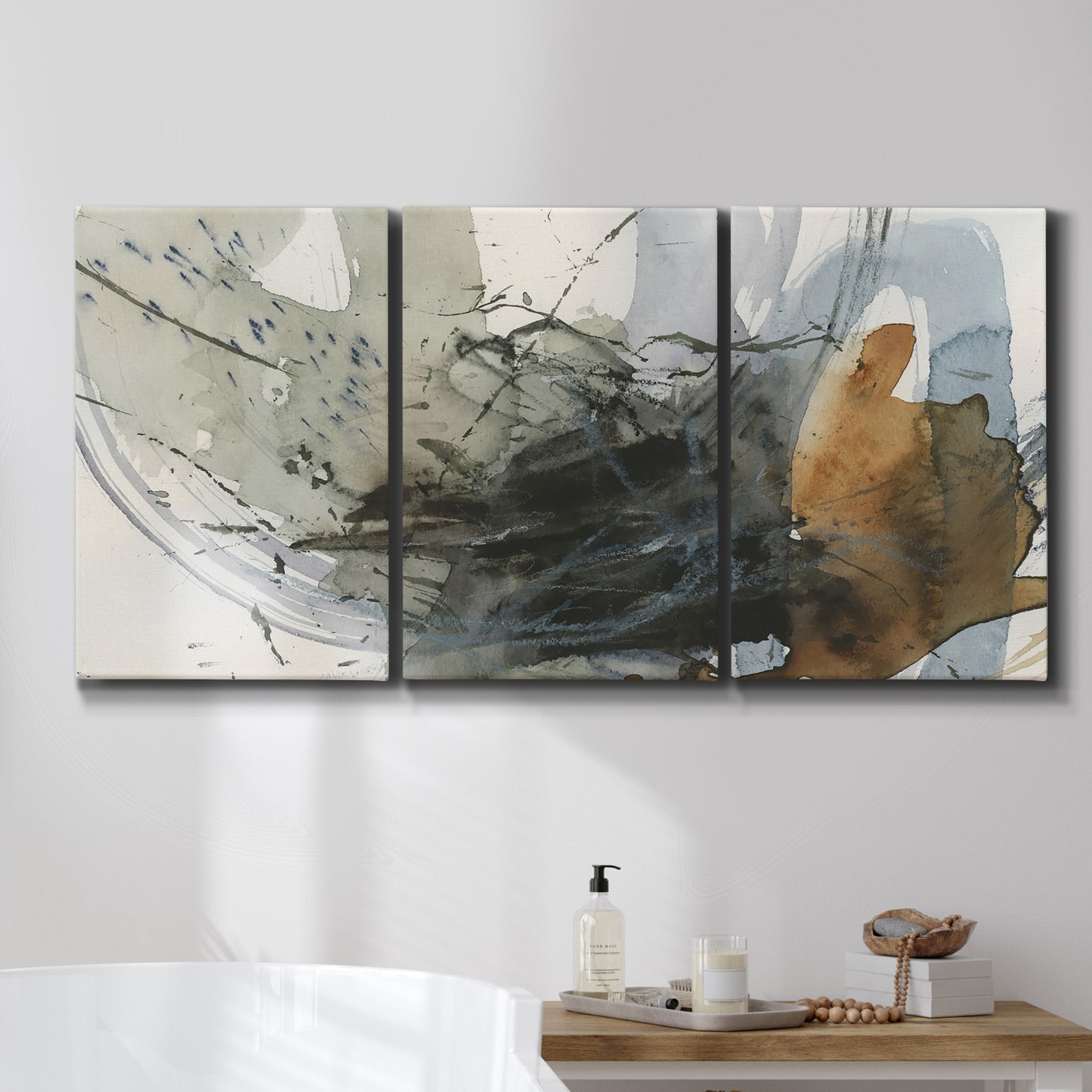 Three-panel canvas wall art featuring dynamic circular abstract motion, displayed in a bathroom above a bathtub.