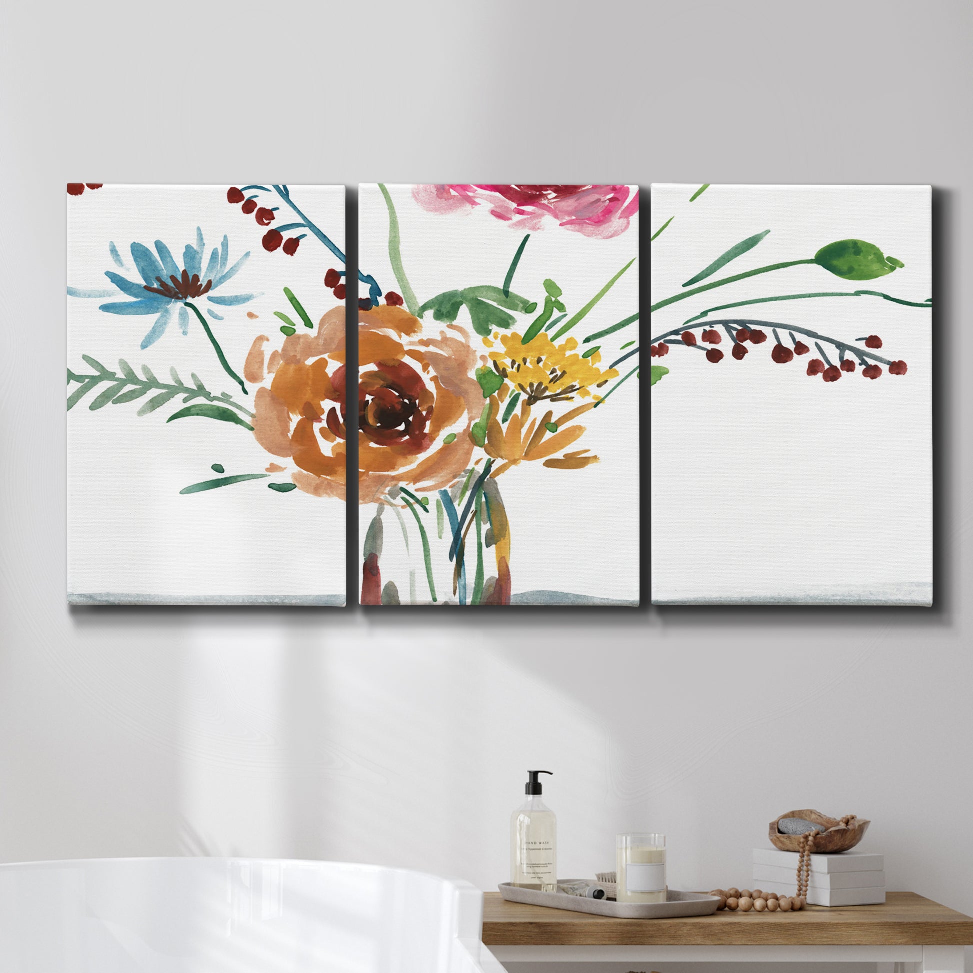 Three-panel canvas wall art featuring vibrant floral bouquet, displayed in a bathroom above a bathtub.