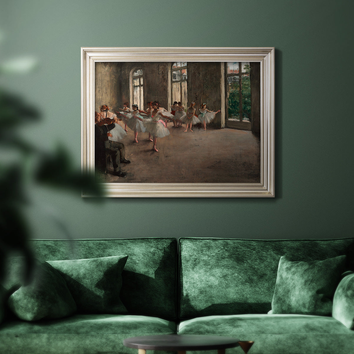 Early impressionist ballet rehearsal painting by Edgar Degas in an ornate champagne frame displayed in a dark-toned interior setting.