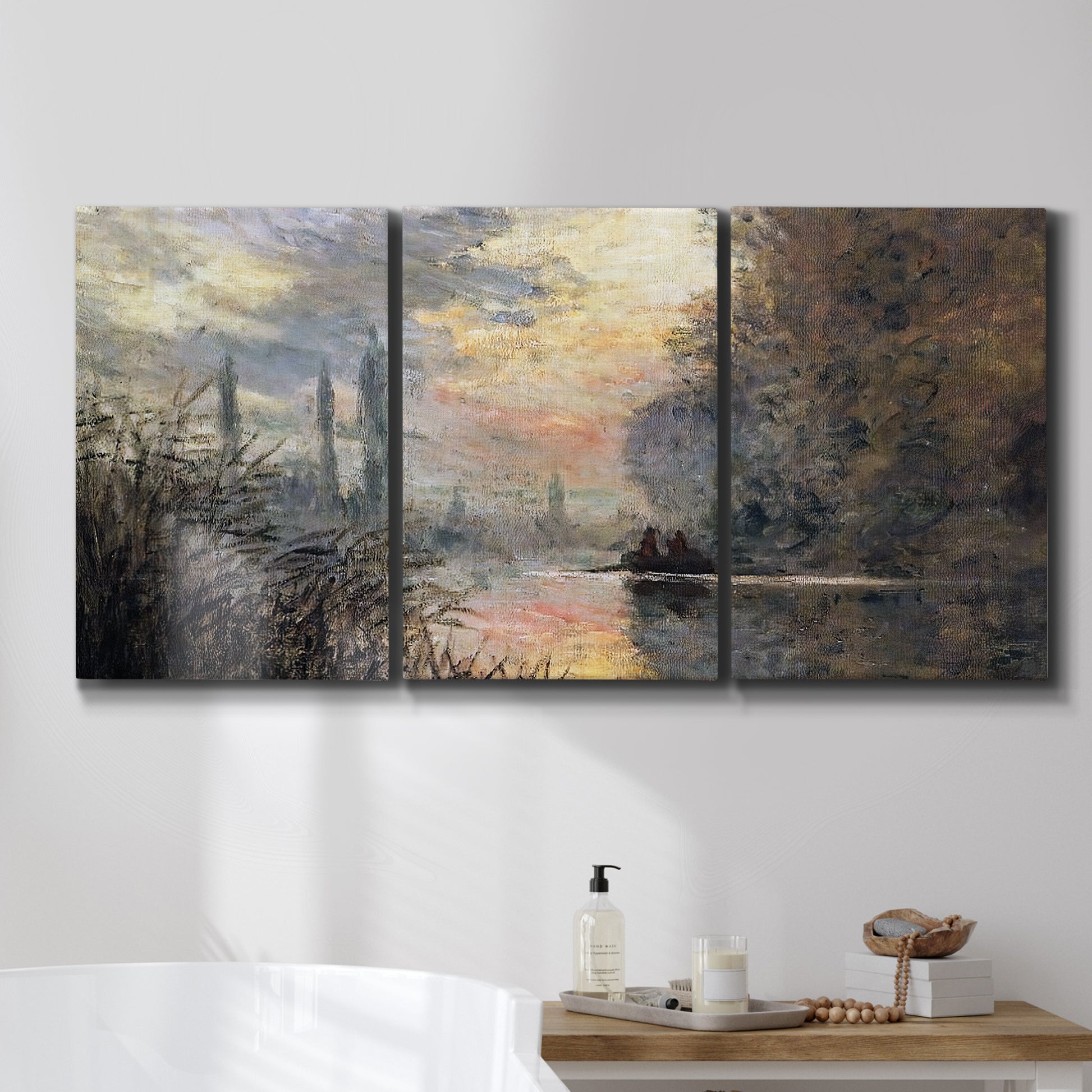 Three-panel canvas wall art featuring winter river sunset with reflections, displayed in a bathroom above a bathtub.