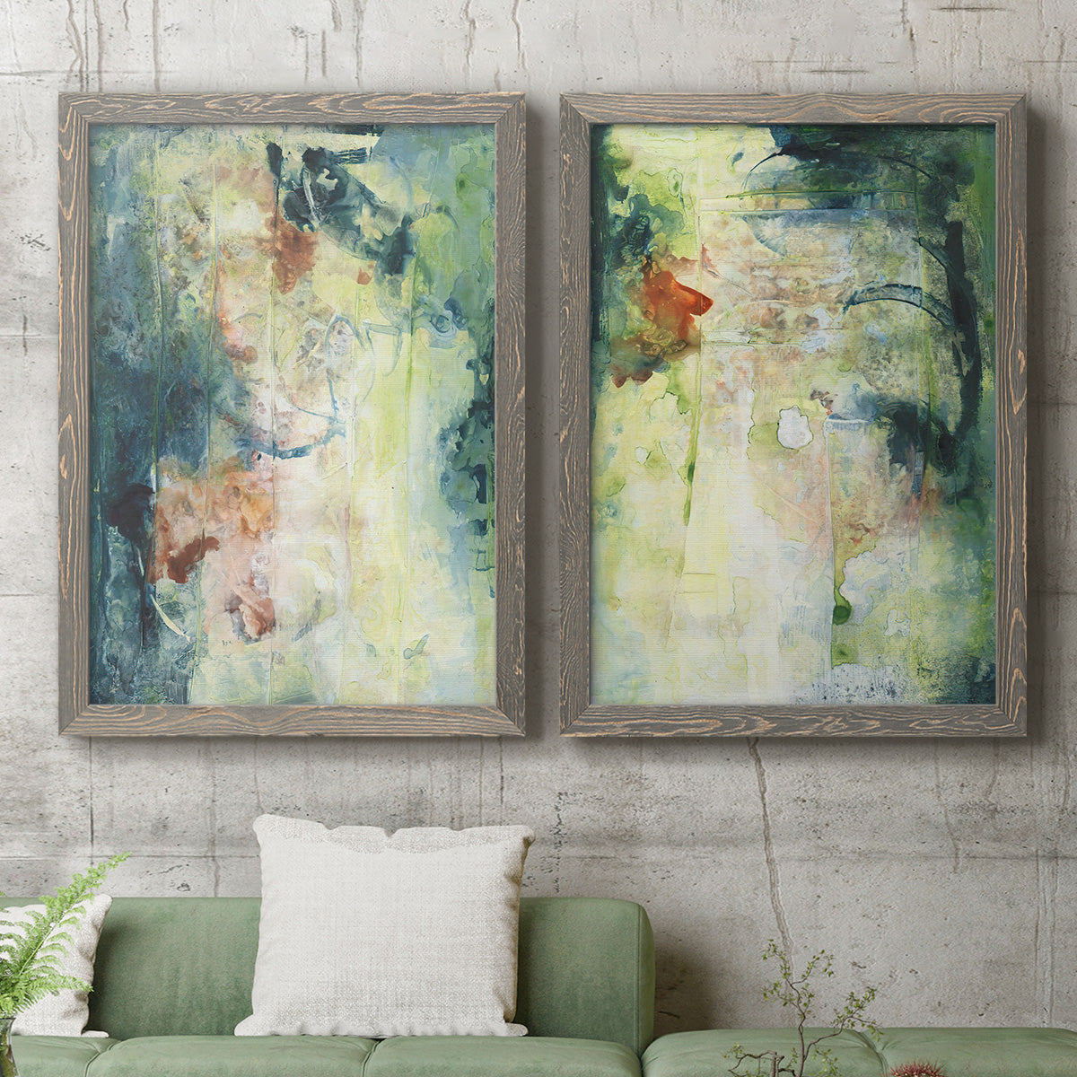 Set of two gray barnwood framed canvas prints depicting a coordinated art pair of layered blue green cream and charcoal textures rendered as nature-inspired mixed-media abstracts above a sofa in a modern living room.
