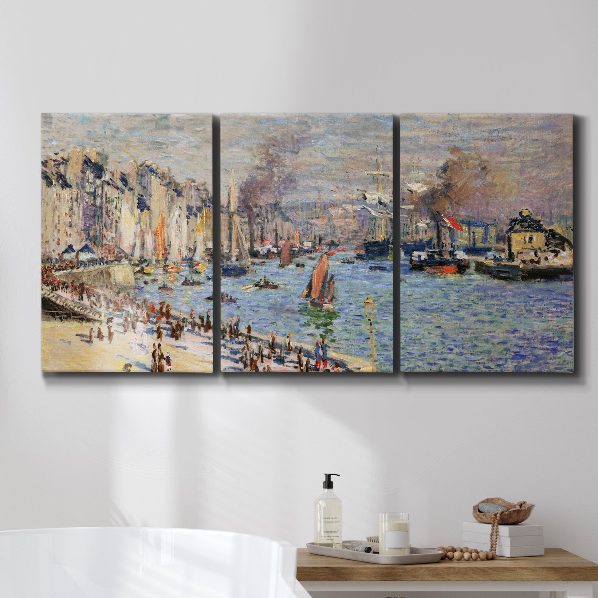 Three-panel canvas wall art featuring evening harbor with reflections, displayed in a bathroom above a bathtub.