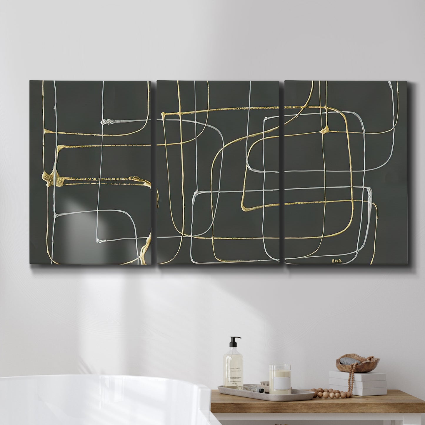 Three-panel canvas wall art featuring linear abstract conduit pattern, displayed in a bathroom above a bathtub.