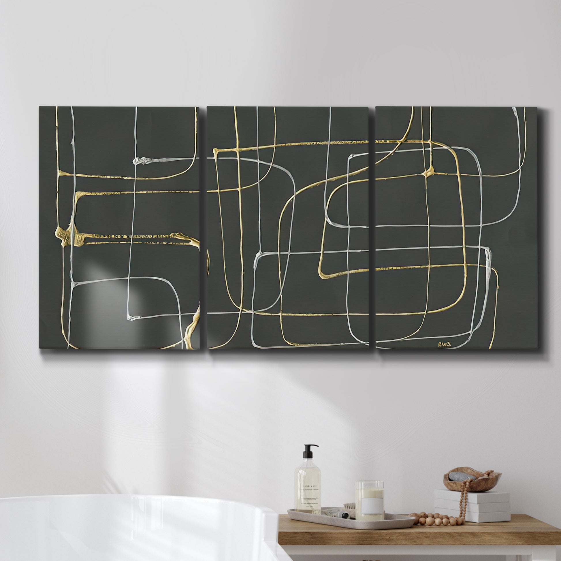 Three-panel canvas wall art featuring linear abstract conduit pattern, displayed in a bathroom above a bathtub.