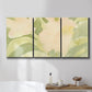Three-panel canvas wall art featuring minimal verdant floral abstraction, displayed in a bathroom above a bathtub.