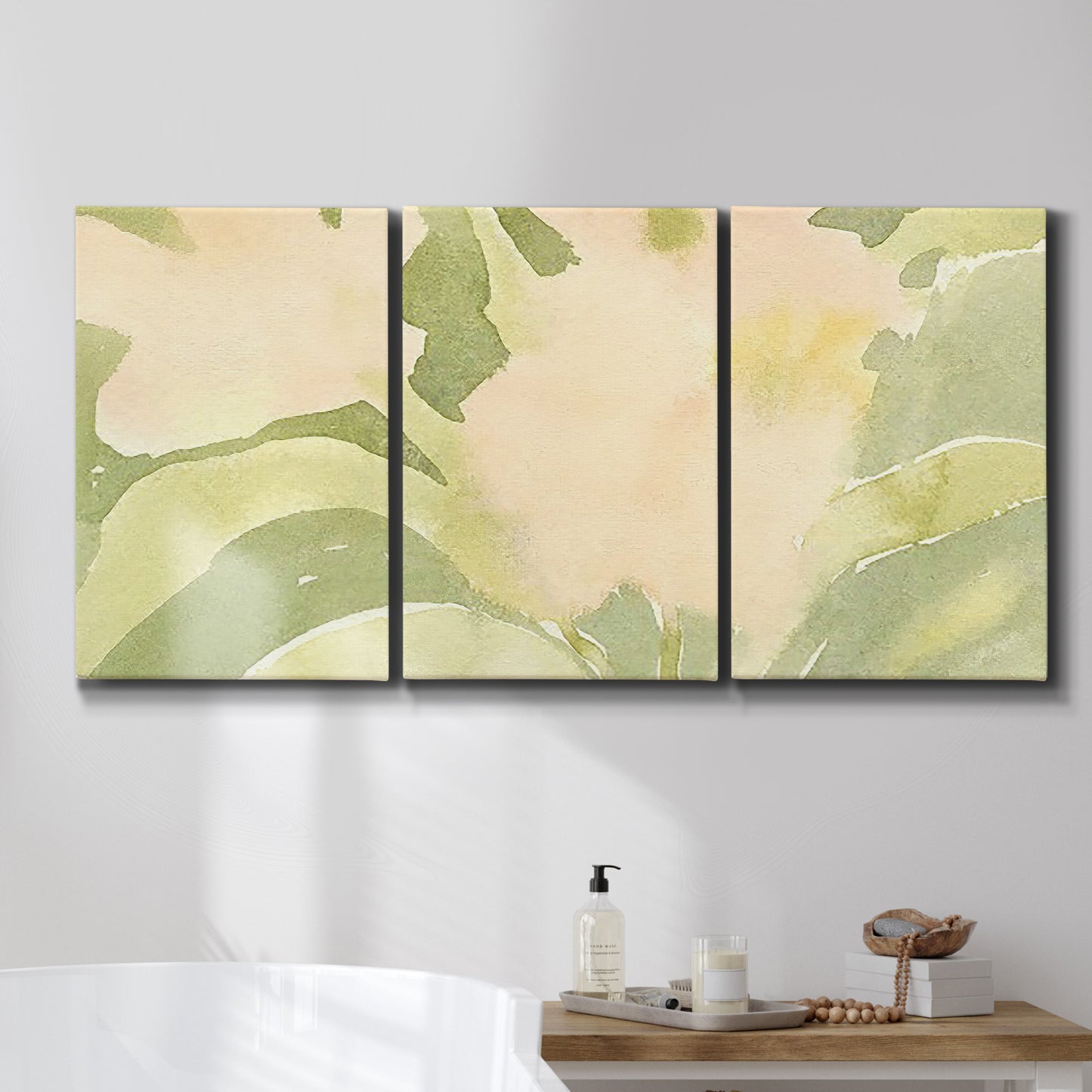 Three-panel canvas wall art featuring minimal verdant floral abstraction, displayed in a bathroom above a bathtub.