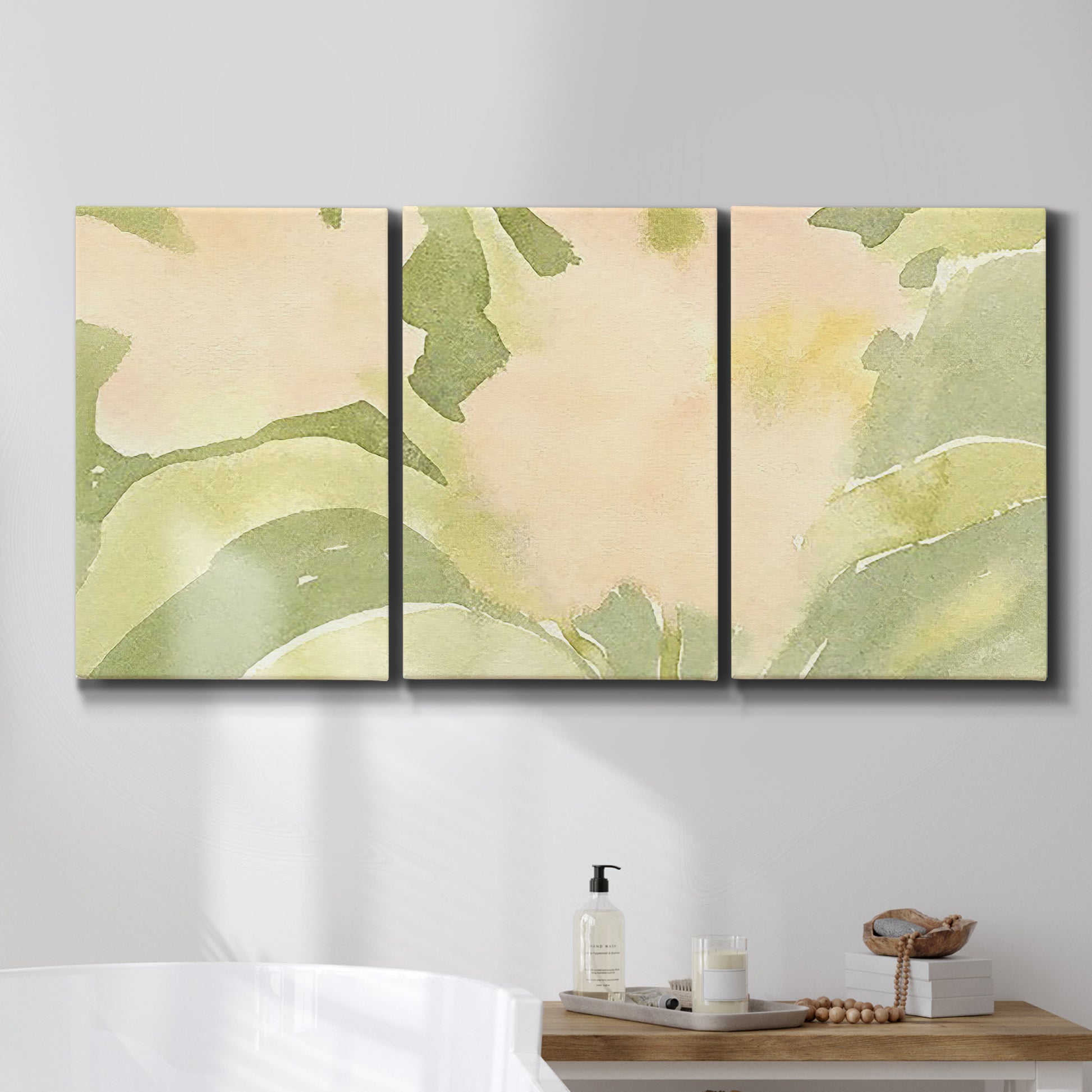 Three-panel canvas wall art featuring minimal verdant floral abstraction, displayed in a bathroom above a bathtub.